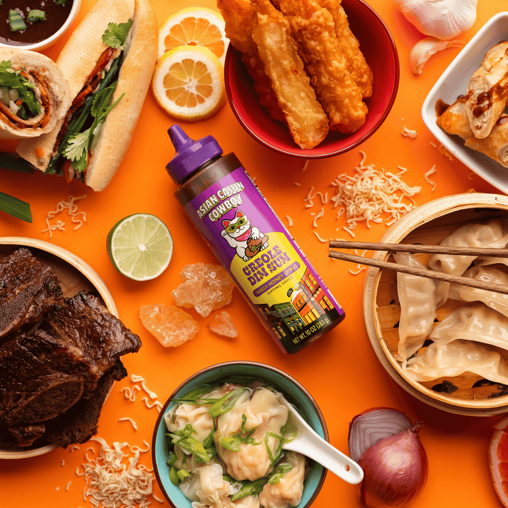 Creole Dim Sum bottle surrounded by asian cuisine on an orange background.