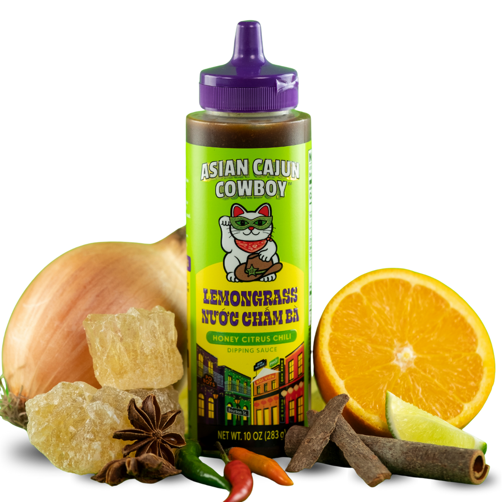 Bottle of Asian Cajun Cowboy Lenongrass Nuoc Cham Ba with ingredients on a white background