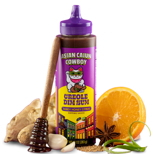 Squeeze bottle of Asian Cajun Cowboy Creole Dim Sum dipping sauce with ingredients on a white background