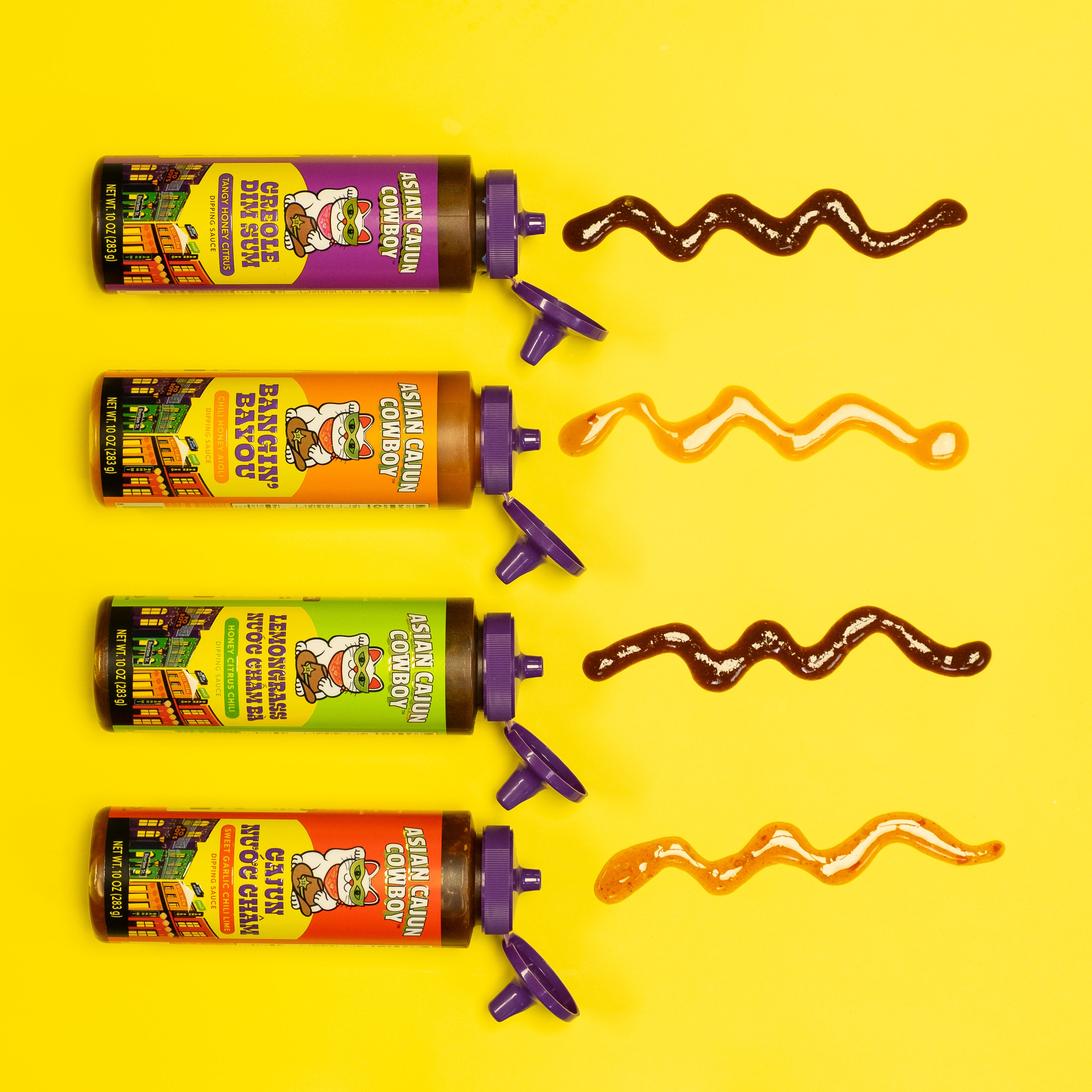 Four tubes of sauce with colorful labels on a yellow background