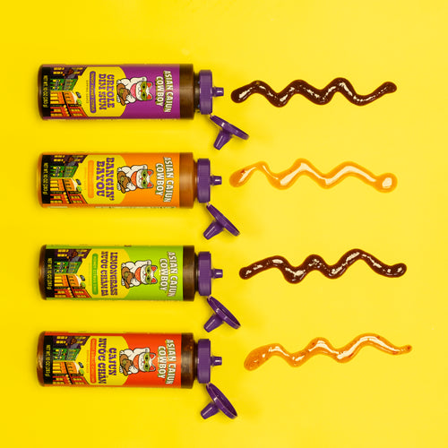 Four tubes of sauce with colorful labels on a yellow background